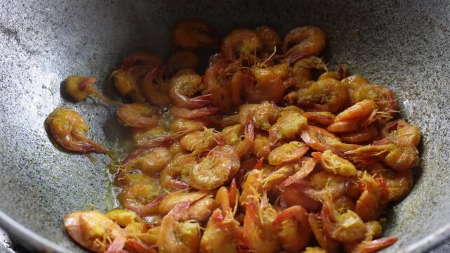 Fried shrimp cooking in pan crispy seafood preparation process