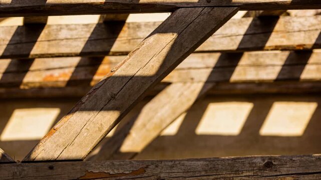 Sunlight shifting, diagonal beam crossing slats, moving shadow grid revealing texture for design