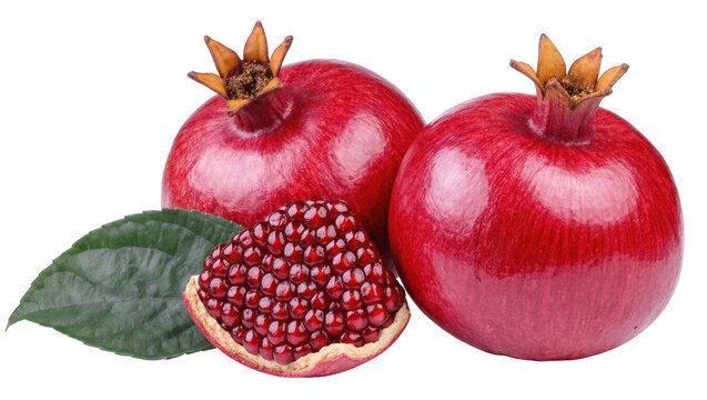 Delicious fresh ripe pomegranates with juicy arils and a green leaf, healthy antioxidant fruit