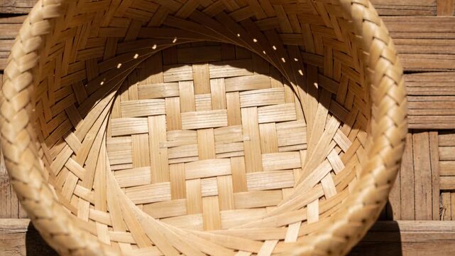 Cut starting zooming camera into bamboo basket, sunlight showing rim holes and grain for detail