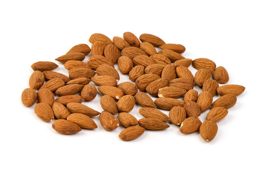 Raw shelled almonds, scattered, isolated on white background