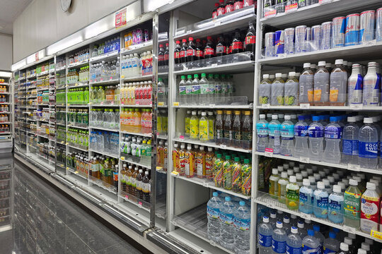 Oita, Japan - Jan 07, 2026: Neatly organized rows of bottled water, soft drinks, energy drinks, and tea displayed in large refrigerated walk-in coolers at a 7-Eleven in Oita.