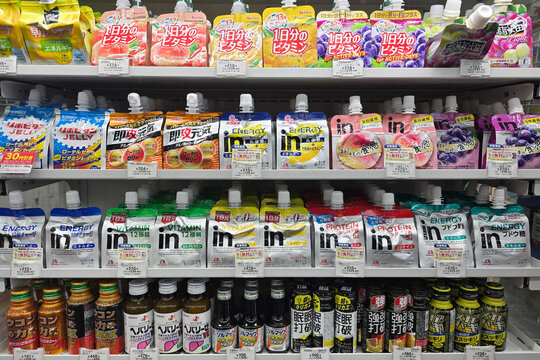 Oita, Japan - Jan 07, 2026: A wide variety of functional energy jelly pouches, vitamin supplements, and bottled health tonics displayed on retail shelves at a 7-Eleven in Oita.