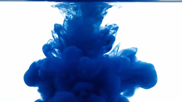Blue Ink Droplet Dissolving in Clear Water Against White Background