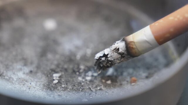 Extreme close up on cigarette in ashtray - video close up 4k	