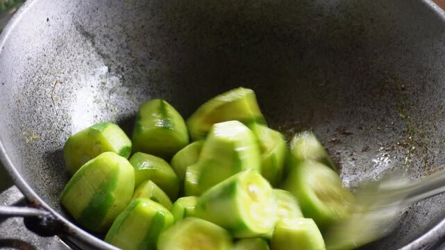 Cooking pointed gourd parwal in pan