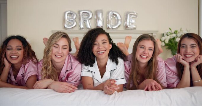 Women, people and face in bed for bridal shower, celebration and smile in hotel bedroom. Group, happy friends and bride in portrait for embrace, solidarity and sisterhood in bachelorette party