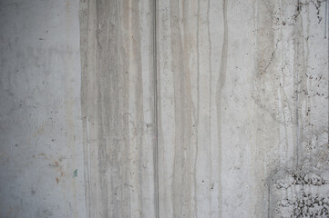 Obraz premium A weathered concrete wall showcases an intricate play of textures and water stains, creating an inspiring background filled with depth for various graphic design endeavors
