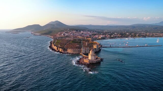 Aerial view of the old venetian Castle and Bourtzi tower in front of the town of Methoni, Messenia, Peloponnese, Greece, during sunset