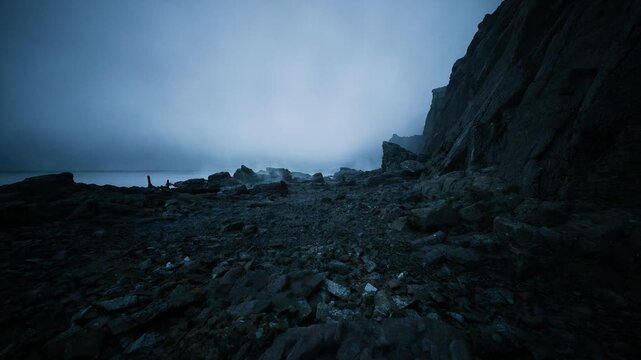 desolate pebble bay beneath looming cliff, scattered boulders and tide pools under deep blue sky, solitary forager role suggested, rugged wet textures,