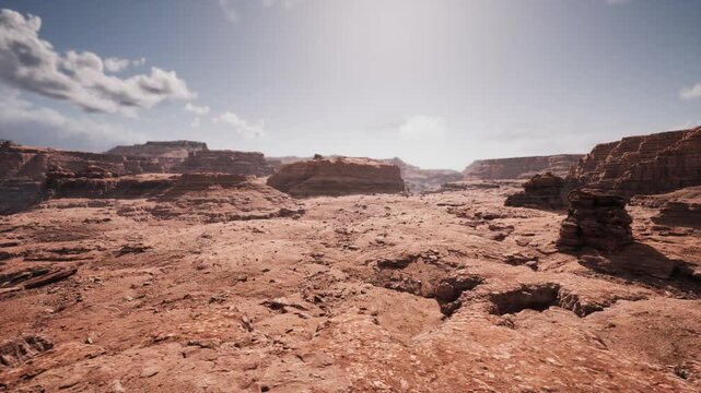 wide canyon formation suited for geological field study, exposed sedimentary layers, eroded cliffs, clear sky, natural laboratory for research, education