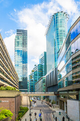 Office skyscrapers and Barbican city development of 1960 in the City of London. Walking people