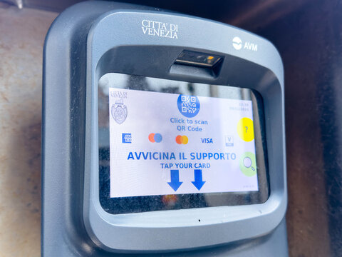 Venice, Italy - February 09, 2026: Payment terminal for public transport in Venice, Italy, displaying QR code scanning instructions and card payment options on the screen
