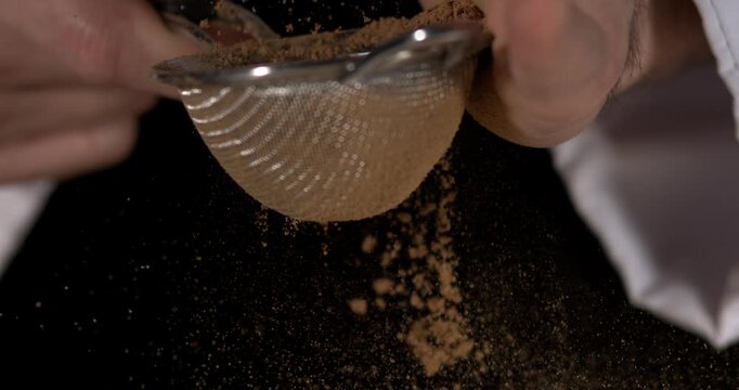 Super slow motion, Detailed Image Showing Chef Pouring Cinnamon Through Metal