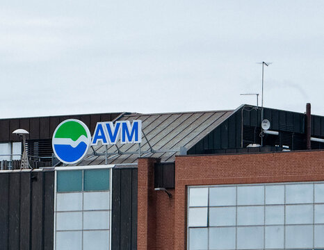 Venice, Italy - February 09, 2026: AVM logo displayed prominently on the rooftop of a modern building with glass windows and a metal roof in an urban setting