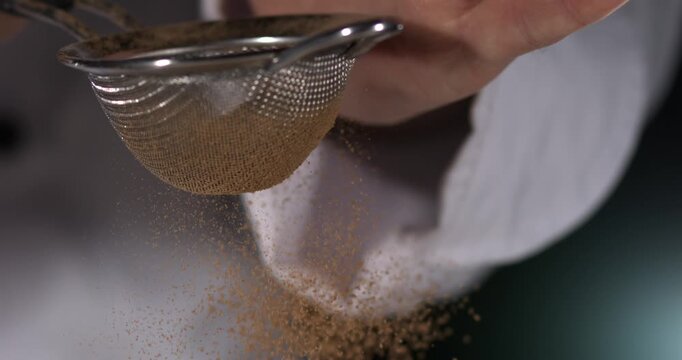 Super slow motion, Closeup Of Chef Dispersing Aromatic Cinnamon Into Mixing Bowl