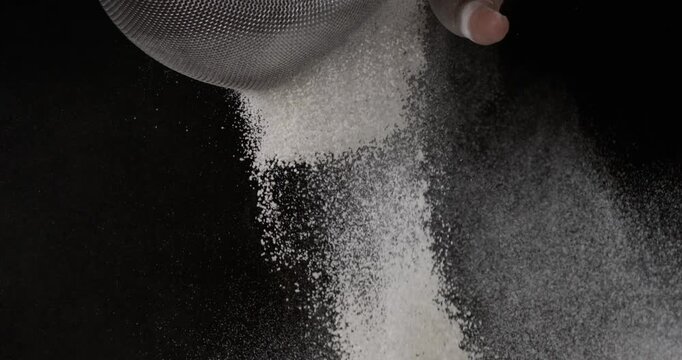 Super slow motion, Artisan Baker Sifting Fine Flour In Dark Studio