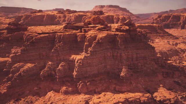 Sunlit canyon rim with distant plateaus and layered mesas under clear sky dramatic shadows emphasize depth of stratified cliffs, panoramic vista invites