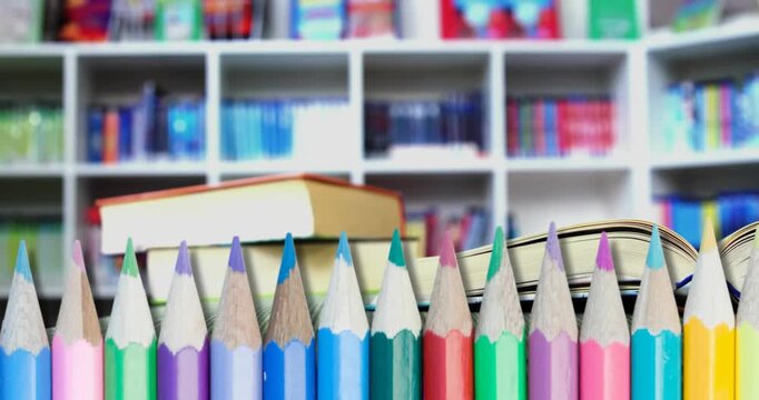 Animation of pencils and schoolbooks over library background