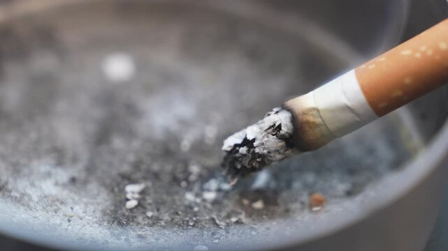 Macro shoot on cigarette in ashtray - video close up 4k	
