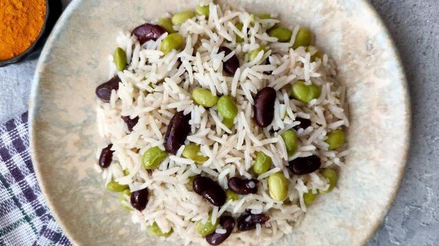 Asian food with rice, edamame, carrots, tofu, and spices. Rice with edamame and carrots as a food background for your design