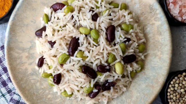 Asian food with rice, edamame, carrots, tofu, and spices. Rice with edamame and carrots as a food background for your design