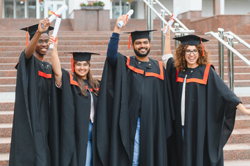 Obraz premium Diverse group of graduates celebrating university graduation day
