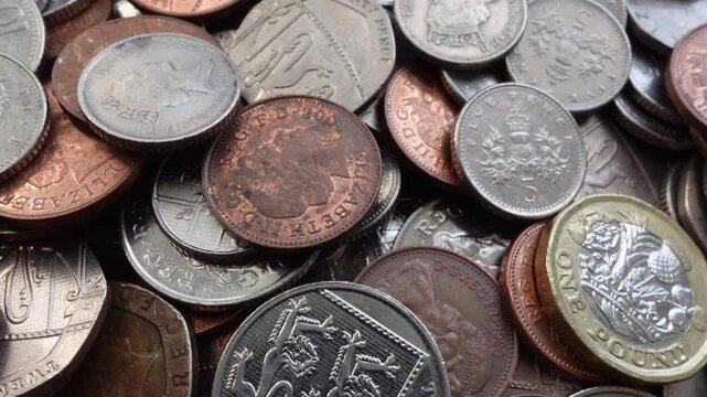 Slow camera movement over UK coins top view