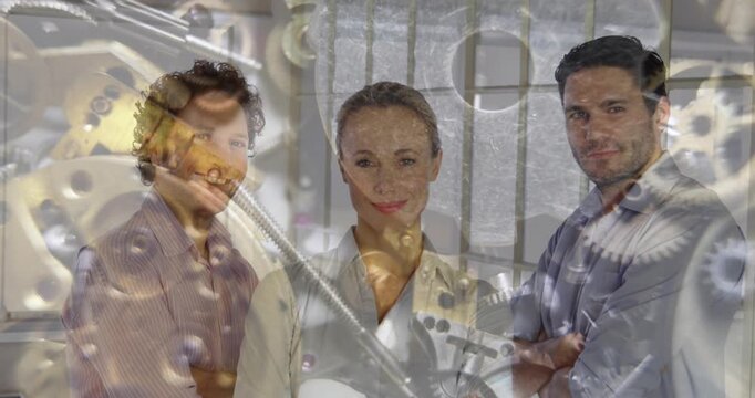 Composite video of three colleagues smiling at office against close up of clock mechanism