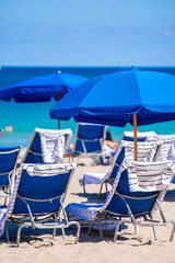Beach chairs with umbrellas and towels on the sand