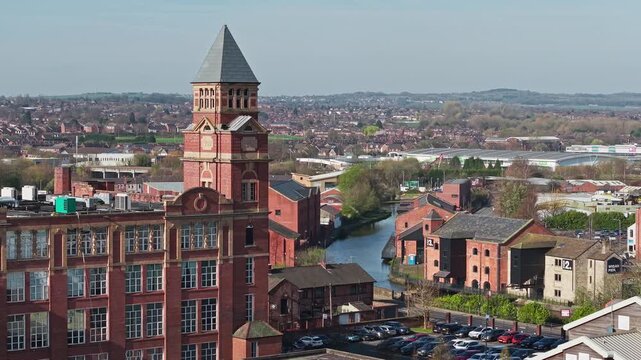 WIGAN, GREATER MANCHESTER, ENGLAND - MARCH 18, 2026: Wigan Pier and industrial mill alongside the Leeds and Liverpool Canal