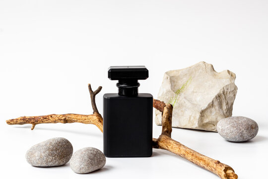 Stylish black perfume bottle with oud wood. Male fragrance concept