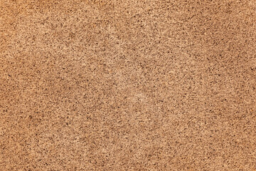 Fototapeta premium Natural stone wall texture featuring rough, porous surfaces and warm brown tones, suitable for architectural backgrounds and creative design use. Ideal for construction and industrial themes.
