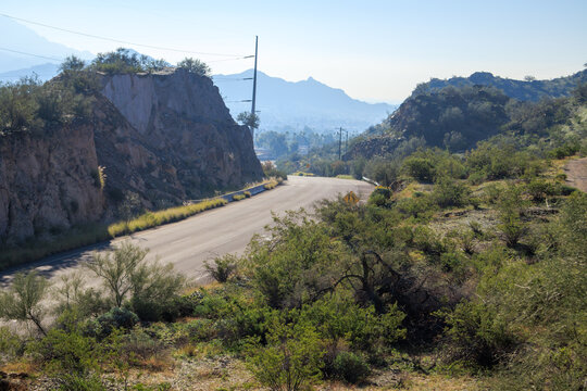 7th Avenue curve between steep slopes of Tapatio cliffs, North Mountain Desert park, Phoenix, AZ; Backlit shot