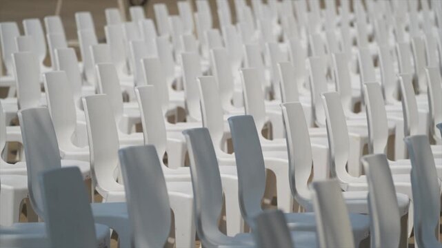 Large scale seating setup with many chairs prepared for an audience in a big event or conference environment.