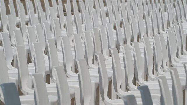 Large scale seating setup with many chairs prepared for an audience in a big event or conference environment.