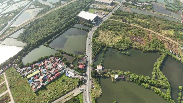 Drone footage reveals Cavite City&rsquo;s coastal bay, where informal settlers line the breakwater and seawall. This powerful aerial scene captures urban density, resilience