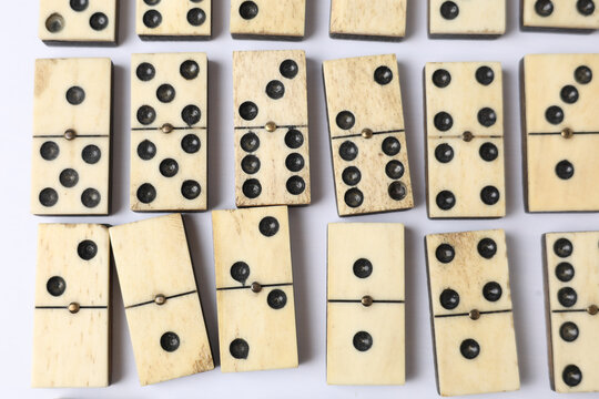 Vintage Domino Tiles on White Background. Aged Texture and Classic Game Pieces Pattern 