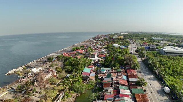 Drone footage reveals Cavite City&rsquo;s coastal bay, where informal settlers line the breakwater and seawall. This powerful aerial scene captures urban density, resilience