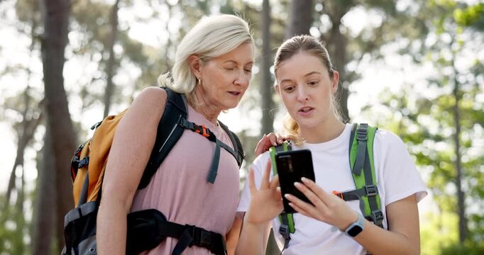 Woman, mother and smartphone in travel, sightseeing or adventure in nature, park or forest. Smile, mature parent and tourist with phone for route research, holiday or vacation in woods for bonding