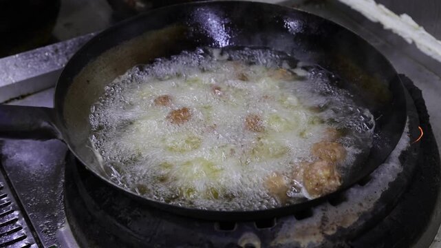 The process of making traditional fried meatballs on-site in the kitchen