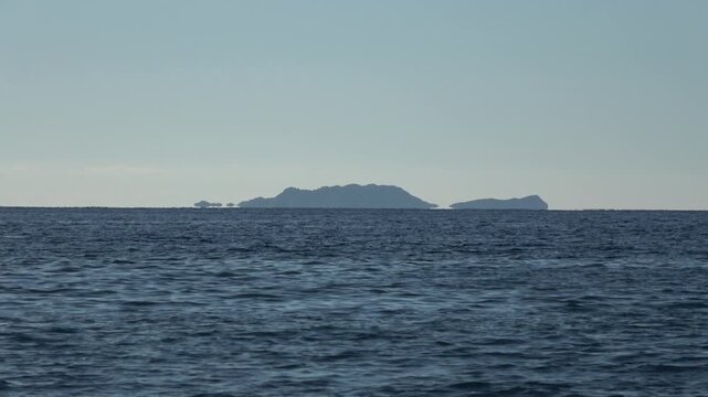 Kas, Turkey - 14 of February 2026: 4K Zoom out Fata Morgana superior mirage of islands over the sea horizon
