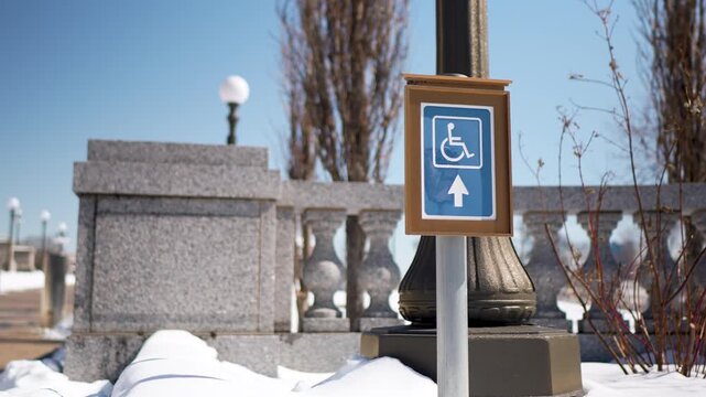 Accessible wheel chair access signs are shown outside the Minnesota Transportation Building at the State Capitol in St Paul in the winter.