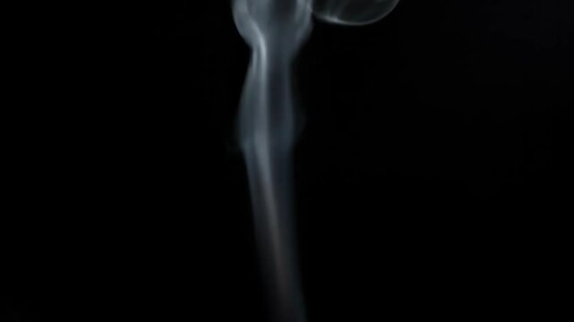 Abstract plume of smoke rising against a dark background