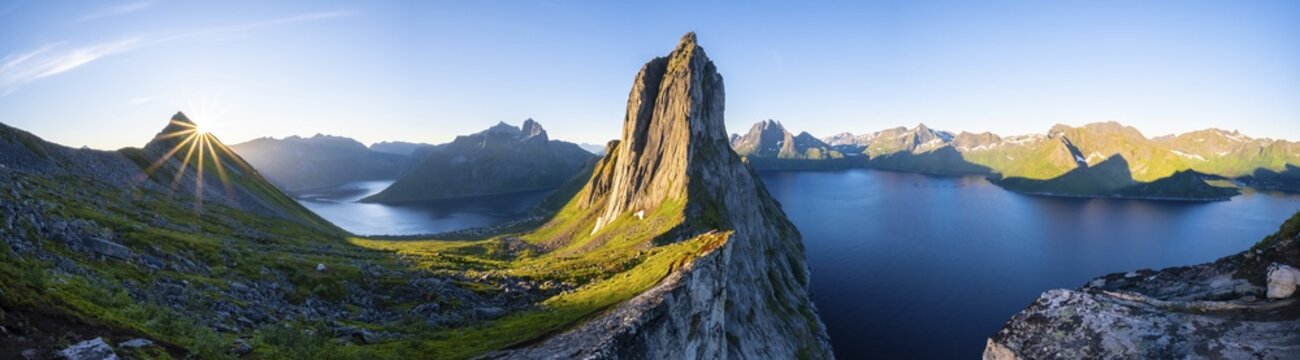 Sun rising over Bergen, morning atmosphere, steep mountain Segla, fjord Mefjorden with Bergen, island Senja, Troms, Norway