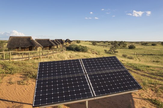 Solar panels near chalets of Rooiputs Lodge, rainy season with green surroundings, Kalahari Desert, Kgalagadi Transfrontier Park, Botswana