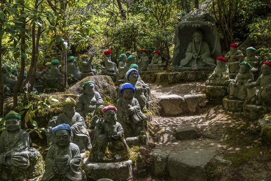 Buddha statue with colorful caps, Daisho-in temple complex, on Itsukushima Island, Miyajima, Hiroshima Bay, Japan