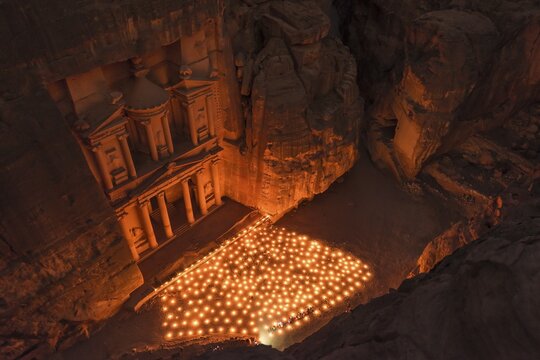 Candles in front of the Pharaoh's treasure house, struck in rock, at night, view from above into the gorge, facade of the treasure house Al-Khazneh, Khazne Faraun, mausoleum in the Nabataean city of Petra, near Wadi Musa, Jordan