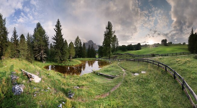 Sunset at Lech da Schutz near Wolkenstein with a bizarre cloudy sky, Puez-Geisler National Park, Wolkenstein, Alto Adige, Italy, Europe