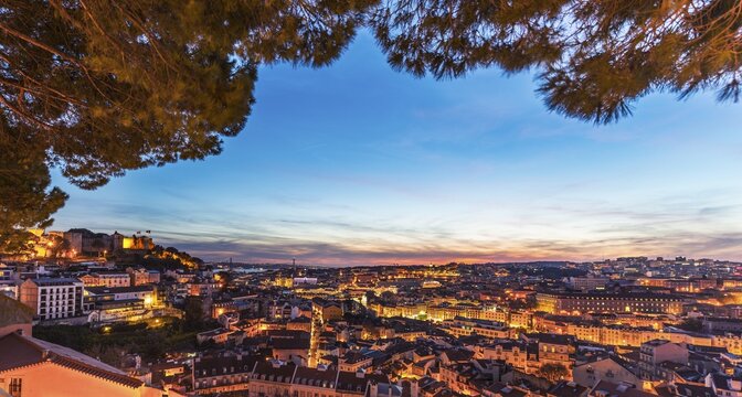 View across Lisbon, S&atilde;o Jorge Castle at dusk, Gra&ccedil;a viewpoint, Lisbon, Portugal